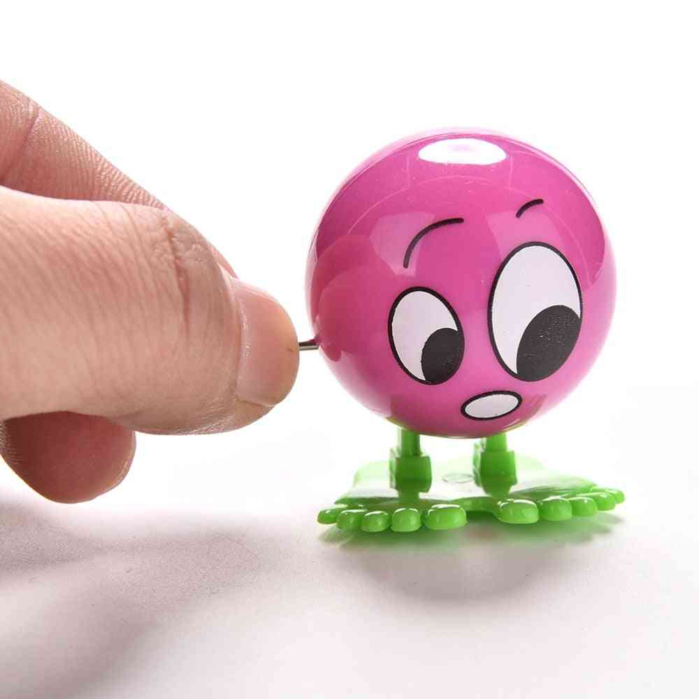 Faccia colorata capriola in esecuzione movimento a molla giocattolo a carica